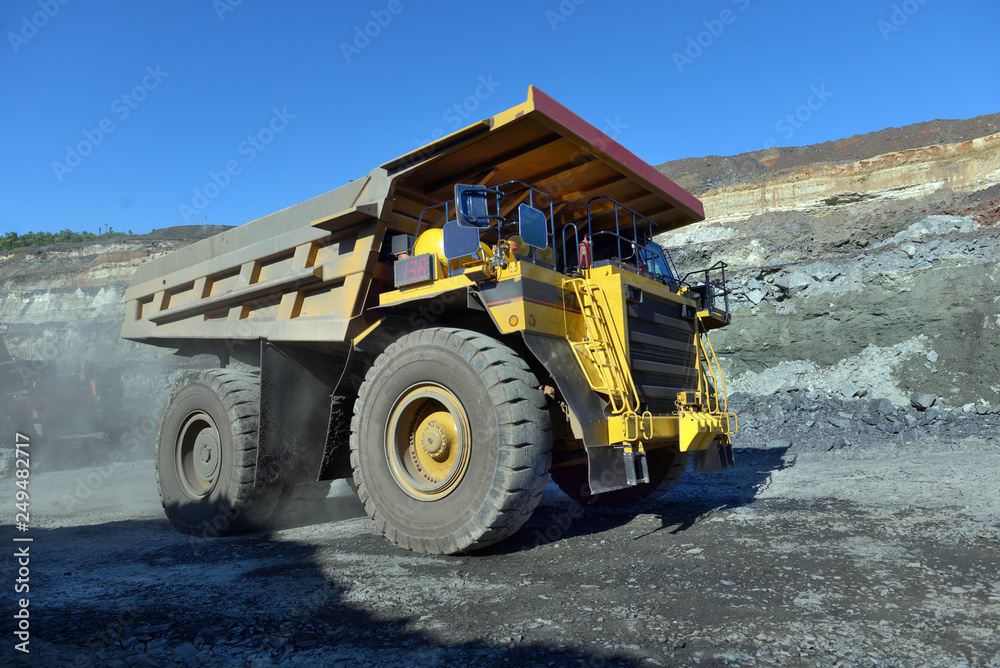 Large quarry dump truck. Loading the rock in the dumper. Loading coal into body work truck