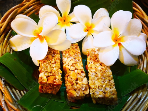 food and dessert concept. Thai sweets are arranged on banana leaves in wicker baskets. And decorated with white flowers. Selective focus and copy space.