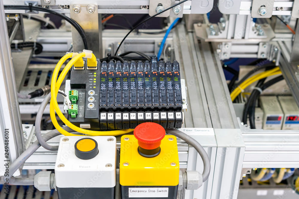 close up emergency stop switch and Ethernet sensor communication unit with fiber optic cable of high performance automatic manufacturing assembly and inspection process at production line