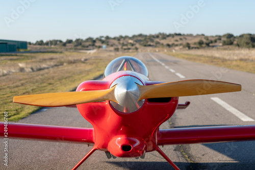 small red propeller plane photo