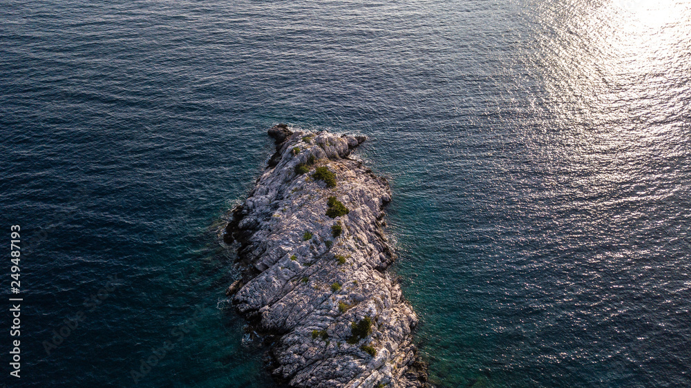 Stone island in the ocean of Croatia, blue ocean with rocks in the middle  Stock Photo | Adobe Stock