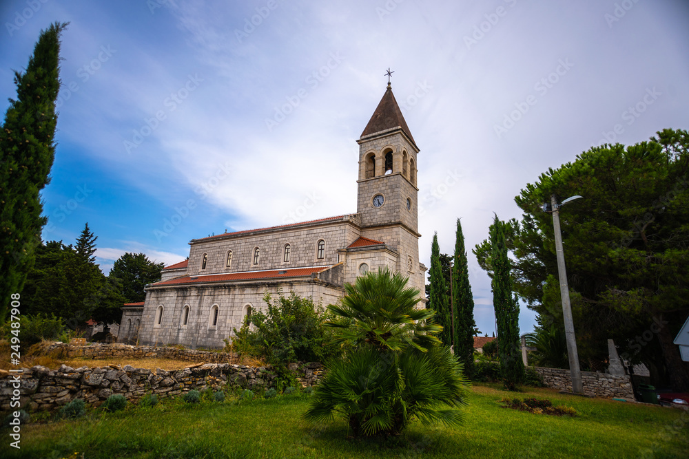 old beautiful church on an island in Croatia, Grohote church Croatia with beautiful blue sky background