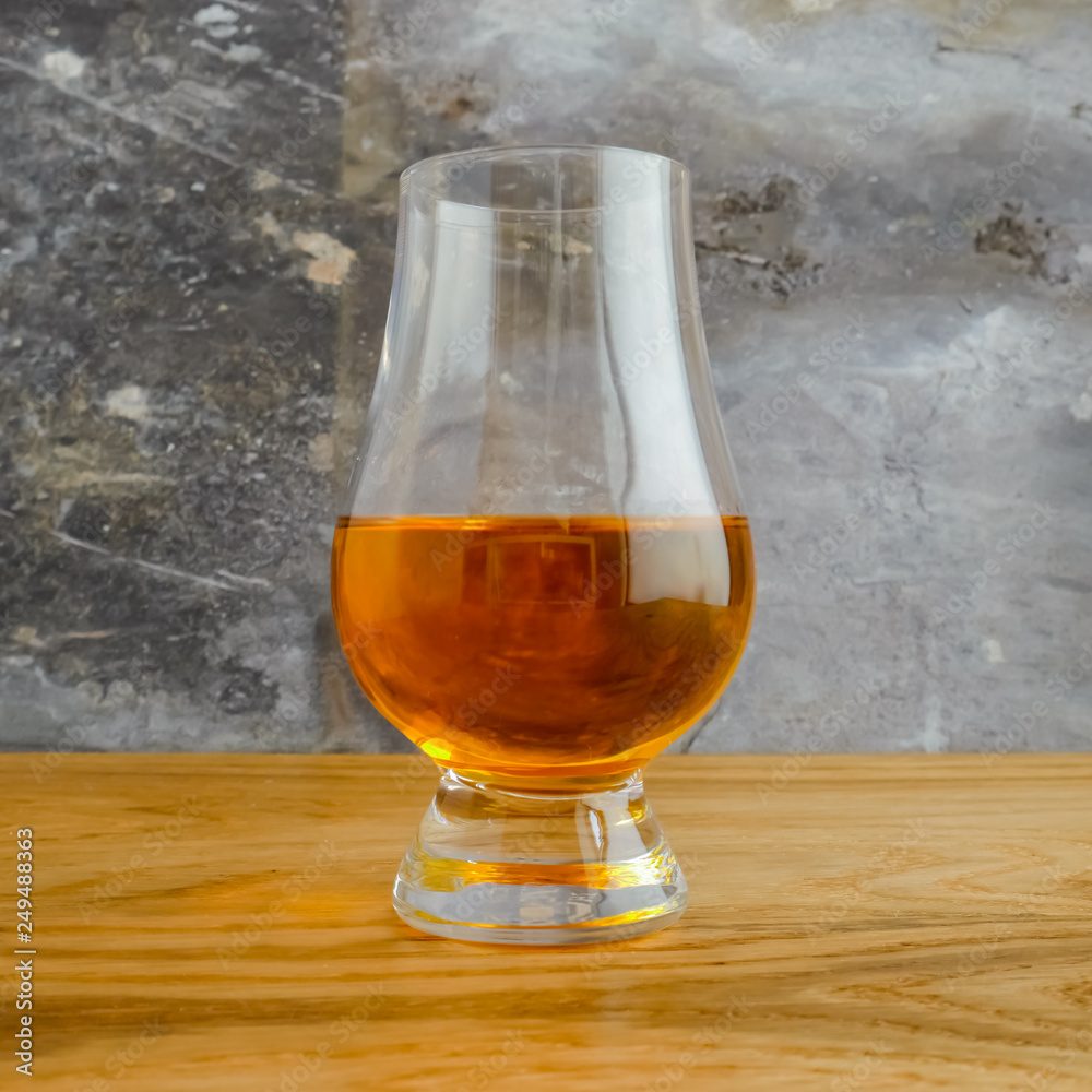 Irish Whiskey Glass on Wood and Slate Background Close Up Square Format Irish Whiskey Glass on Wood and Slate Background Close Up Square Format