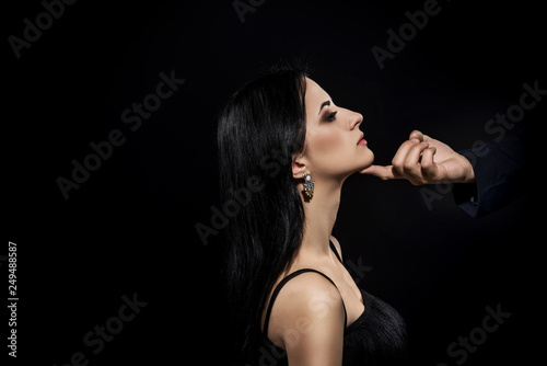 Male hand touches woman face as Sexual Harassment. Man touch woman face photo