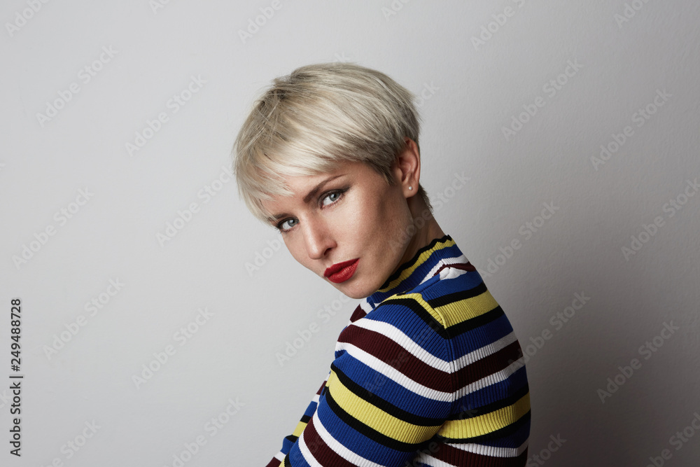 Fashion Portrait of young Fabulous cute stylish girl with red lips looking at camera over white empty background Fashion Portrait of young Fabulous cute stylish girl with red lips looking at camera over white empty background