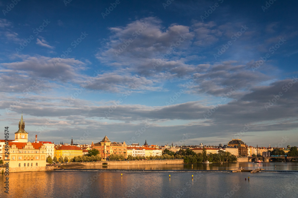 Vltava river and its waterfront in Prague at sunset, Czech Republic, Europe.