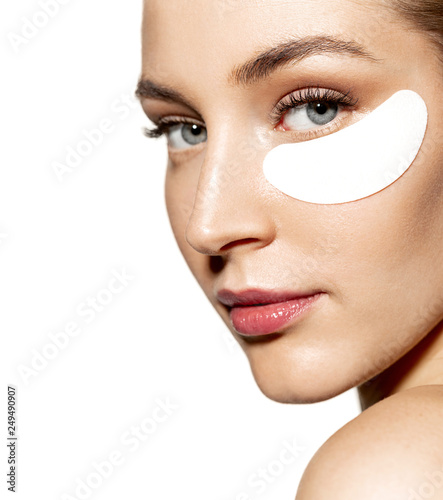 Leinwand Poster Close-up portrait of relaxed woman wearing cosmetic patches under both eyes