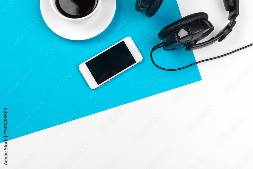 Headphones and coffee cup on blue background, top view - obrazy, fototapety, plakaty 