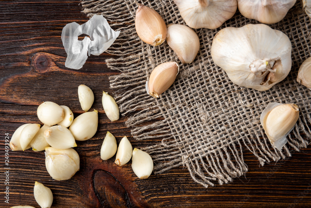 Peeled garlic on dark wooden background. Peeled garlic on dark wooden background.