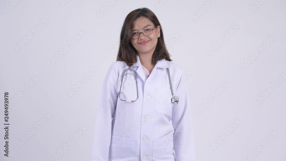 Happy young beautiful Asian woman doctor smiling Happy young beautiful Asian woman doctor smiling