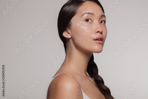Woman trying out new cosmetic cream