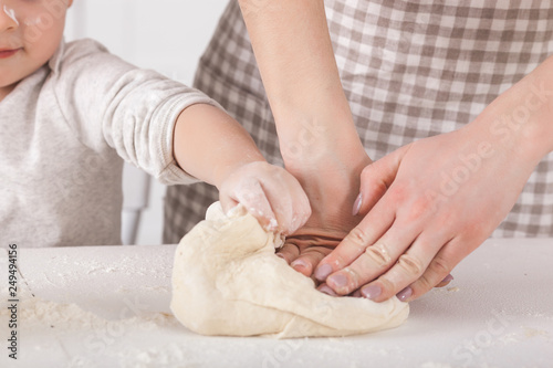 Woman preparing the dough. Closeup still of woman`s hands with daugh and flour. Italian food preparing process.