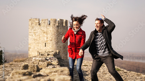 A couple in love dancing and jumping on a castle photo