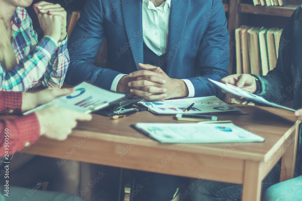 business team discussing a financial report on the company's pro business team discussing a financial report on the company's pro