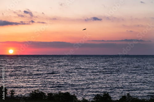 Sunrise or sunset over the sea. Sunrise clouds. Sun appeared from the horizon.