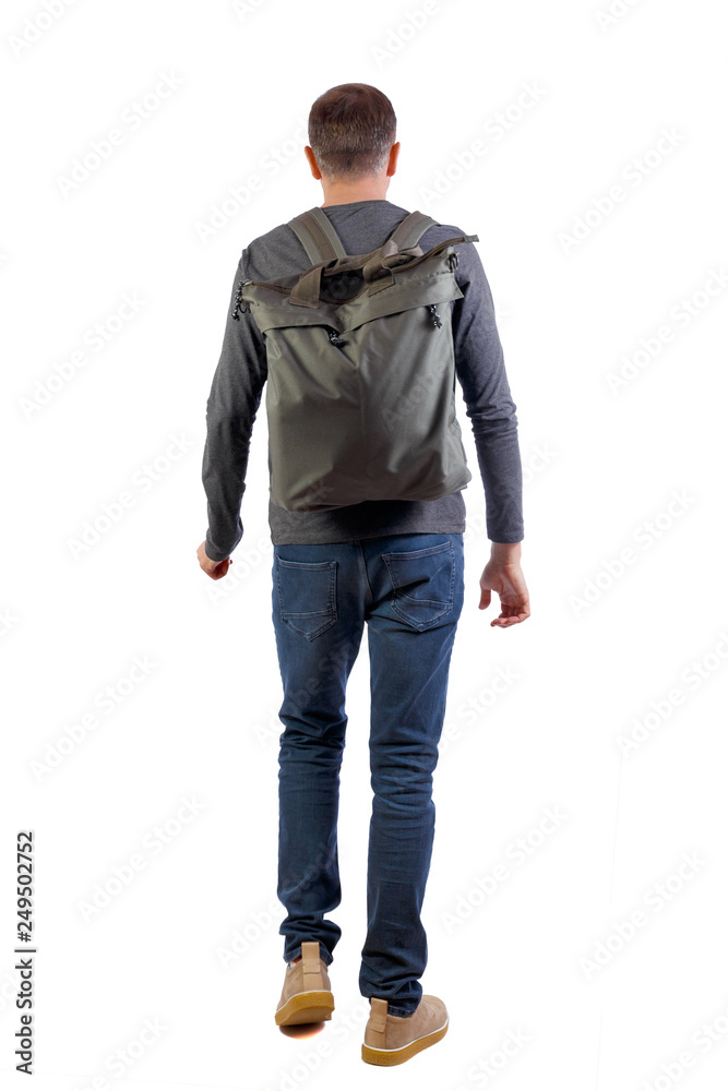 Fototapeta premium back view of walking man with green bag.