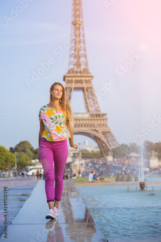 Happy girl walking in centre of Paris. Background of Eiffel tower. Travel concept © Max Topchii