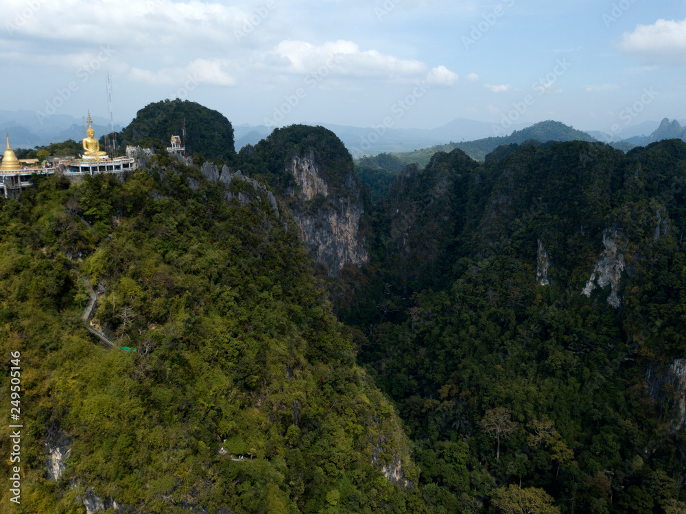 Aerial image of big Buddha on the top of Tiger Cave Temple, Wat Thum Sua, Krabi, Thailand. Aerial image of big Buddha on the top of Tiger Cave Temple, Wat Thum Sua, Krabi, Thailand.