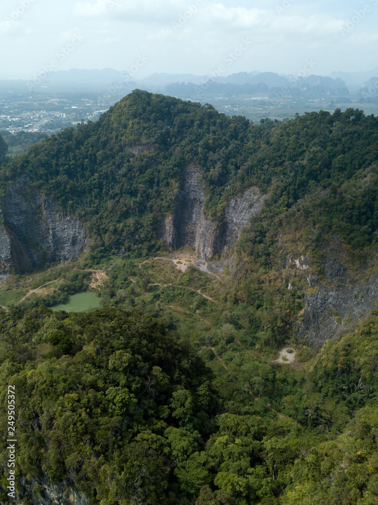 Aerial view of green nature and rocks near TIger Cave Temple in Krabi, Thailand. Photo from drone.