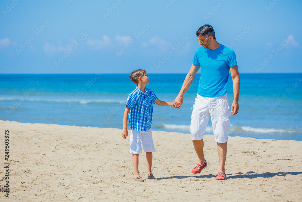 Father and son having fun at beach together. Father and son having fun at beach together.