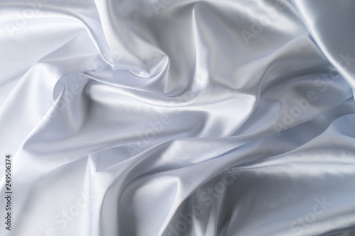 close-up of a piece of white satin fabric. Minimal color still life photography