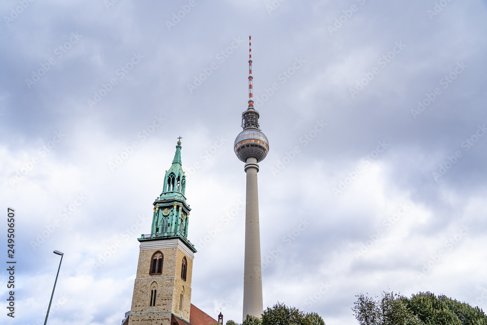 tv tower Berlin isolated on natural blue sky background, The TV Tower located on the Alexanderplatz in Berlin, Germany, tv tower with the st. Mary church in berlin