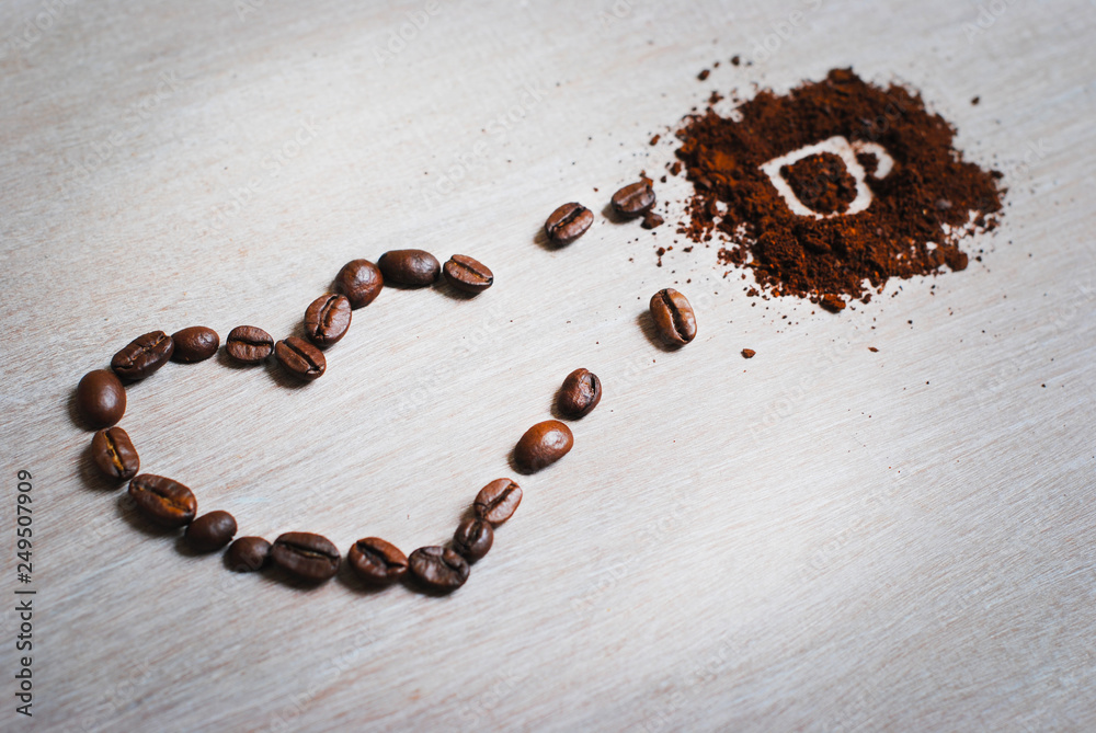 Coffee beans heart of coffee beans turning into a cup. Cup made of coffee beans with heart on the light canvas. Coffee beans heart of coffee beans turning into a cup. Cup made of coffee beans with heart on the light canvas.