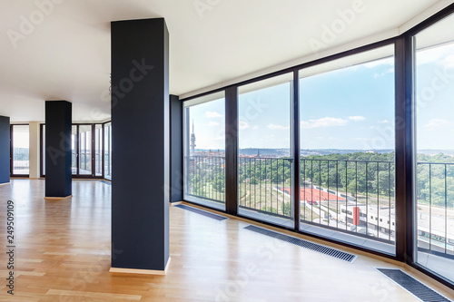 Modern white empty loft apartment interior with parquet floor and panoramic windows, Overlooking the metropolis city
