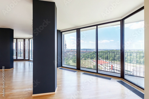 Modern white empty loft apartment interior with parquet floor and panoramic windows, Overlooking the metropolis city