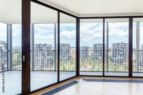 Modern white empty loft apartment interior with parquet floor and panoramic windows, Overlooking the metropolis city