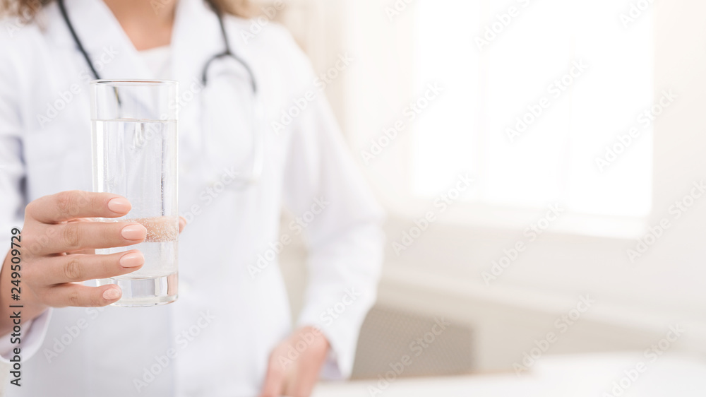Doctor holding glass of clear fresh water Doctor holding glass of clear fresh water