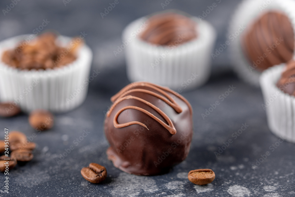 Homemade sweets with coffee filling on a dark background. Homemade candy. Macro. Homemade sweets with coffee filling on a dark background. Homemade candy. Macro.