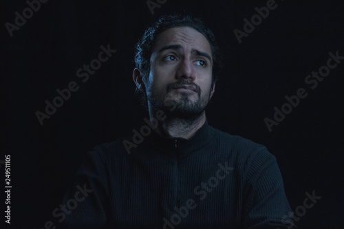 portrait of man meditating in shadows low key