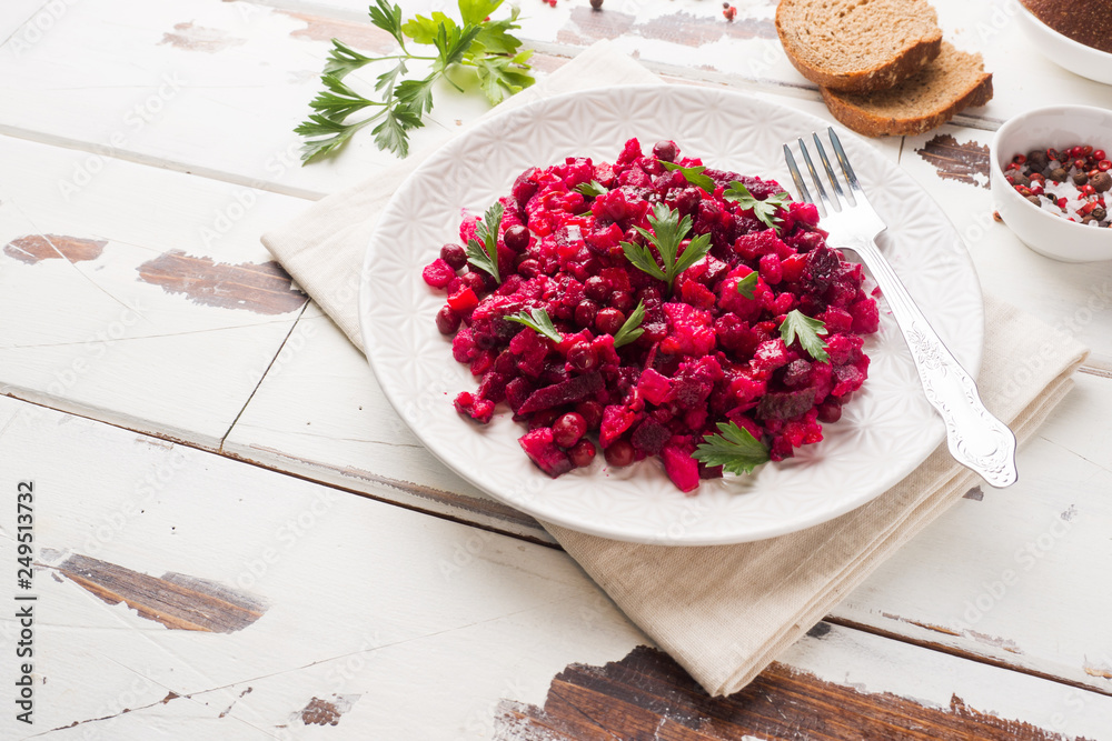 Fresh homemade Beetroot salad Vinaigrette in a white bowl. Traditional Russian food. Copy space