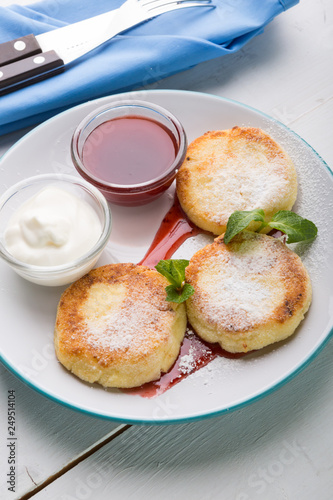 Fritters served with jam and cream for breakfast