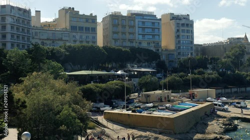 Shot over St Julain`s Bay in Sliema, Valetta, Malta, boats on land photo