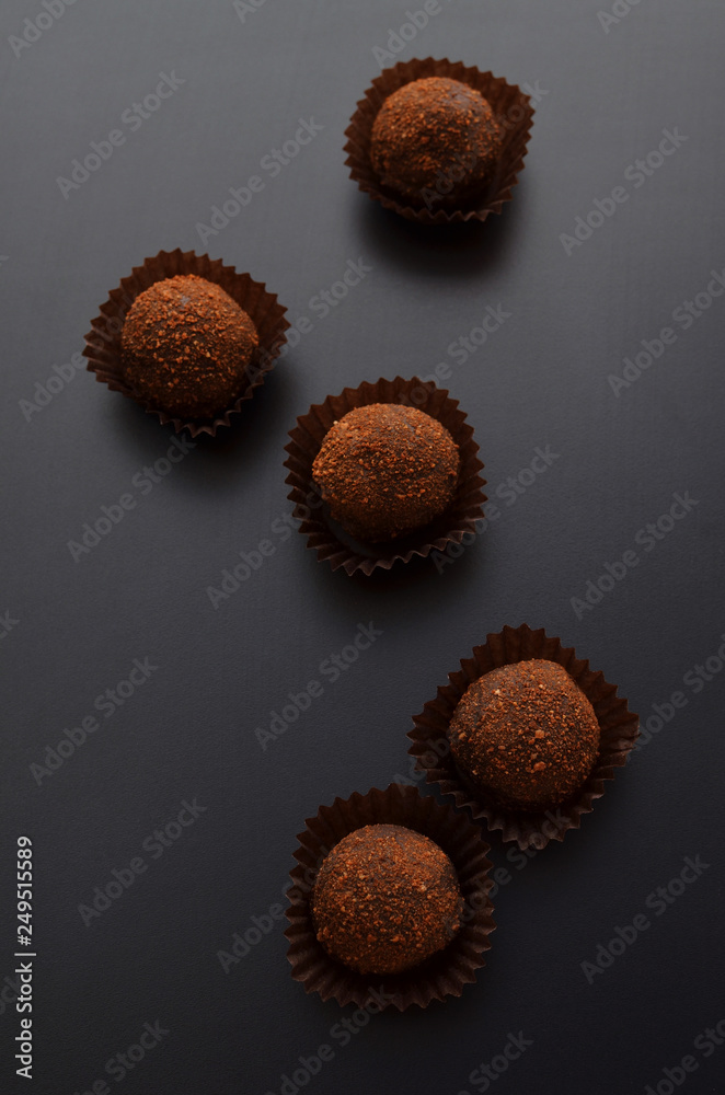 chocolate pralines over black background. Top view. chocolate pralines over black background. Top view.