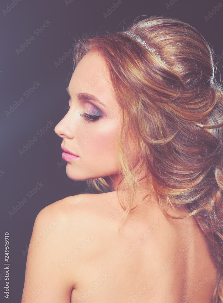 Beautiful woman with curly long hair on dark background . Beautiful woman with curly long hair on dark background .