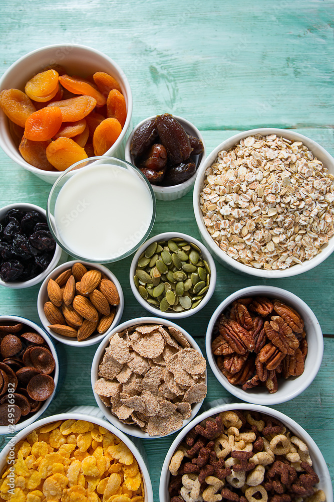 various cereals, nuts and dried fruits on wooden surface various cereals, nuts and dried fruits on wooden surface