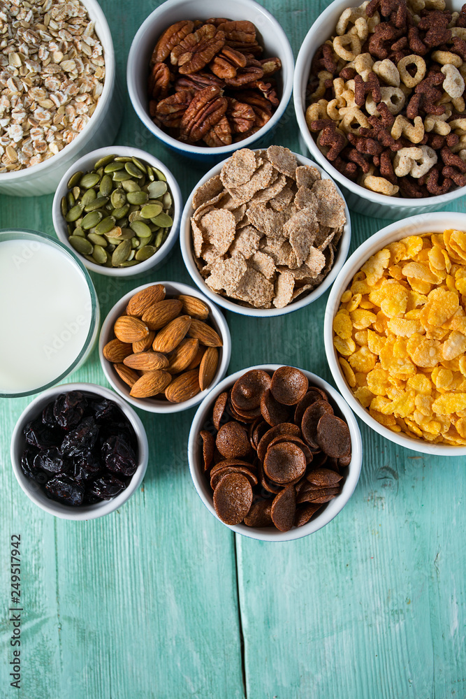 various cereals, nuts and dried fruits on wooden surface various cereals, nuts and dried fruits on wooden surface