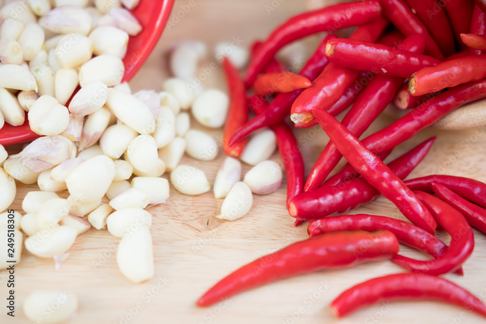 Fresh garlic and red chilli on wood background Fresh garlic and red chilli on wood background