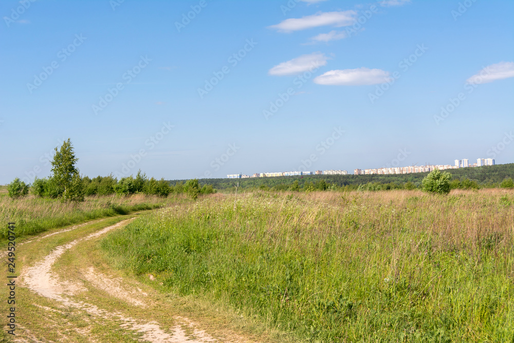Country road in the field, landscape. Away new city district Domodedovo, Russia Country road in the field, landscape. Away new city district Domodedovo, Russia