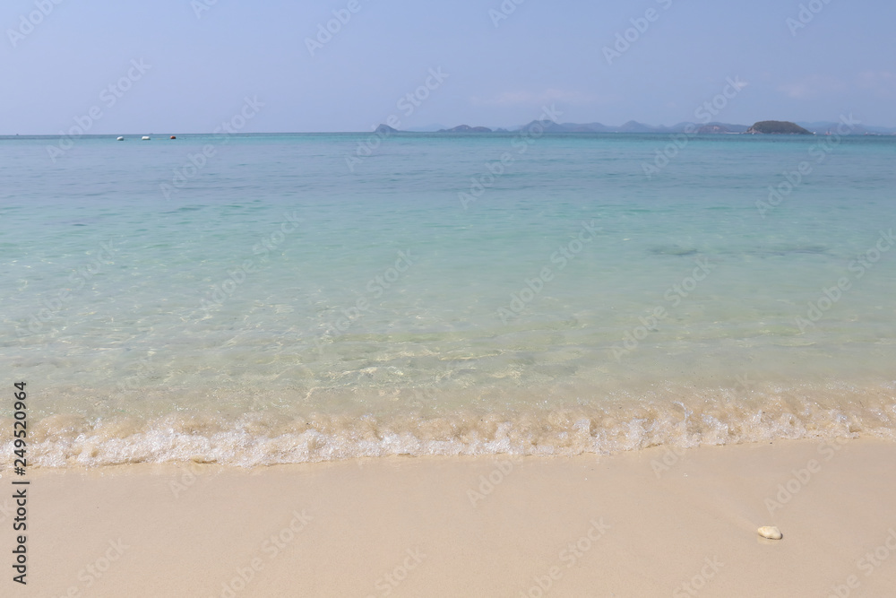Beautiful sandy beach and soft blue ocean wave
