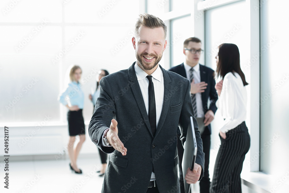 smiling businessman giving his hand for a handshake smiling businessman giving his hand for a handshake