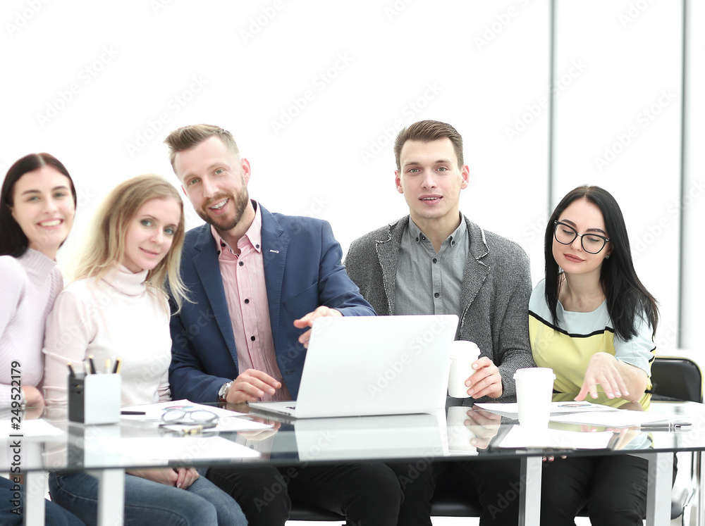 business team sitting together at the Desk. business team sitting together at the Desk.