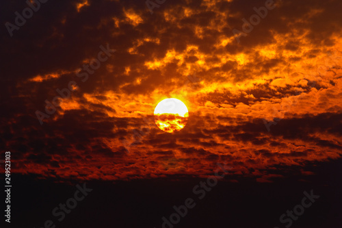 Big sun on dark cloud