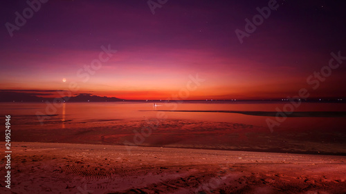 sunset at a beach in purple and multi colored scene the sea in low tide, a tranquility in a summer evening vacation mood © photo-vista.de