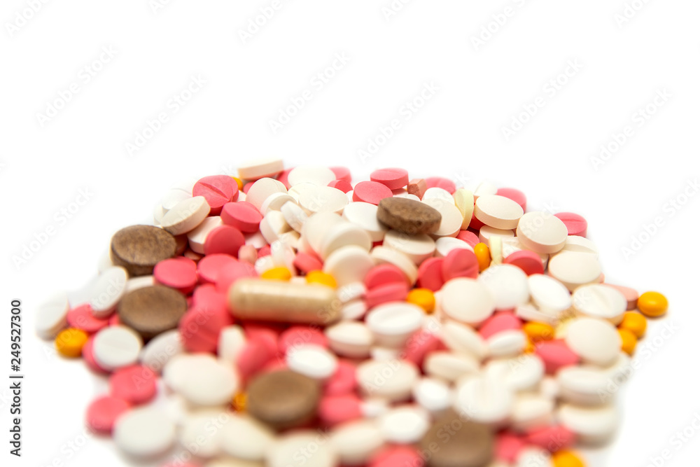 Colored pills and tablets on a white background Colored pills and tablets on a white background