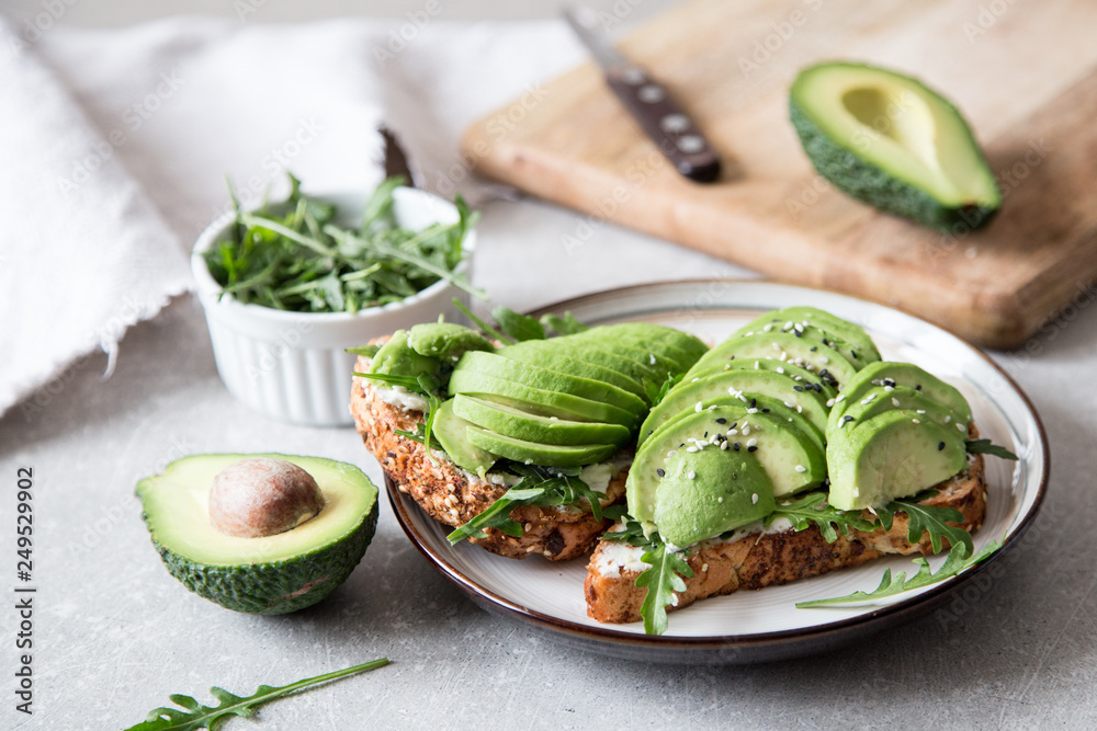 healthy breakfast with avocado and Delicious wholewheat toast. sliced avocado on toast bread with spices. Mexican cuisine - obrazy, fototapety, plakaty 