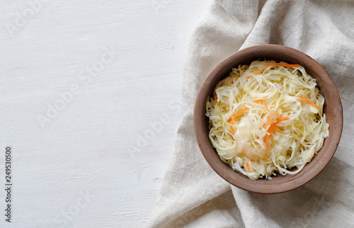 Top view of bowl of sauerkraut with cabbage on towel photo